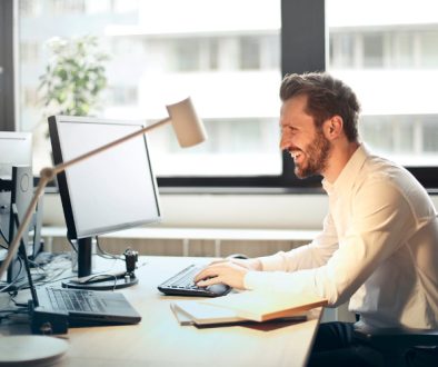 man sitting at a desk looking at his computer